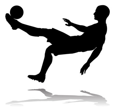 A soccer or football player in silhouette
