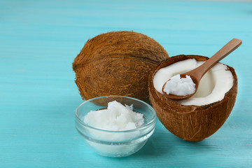 Composition with organic coconut oil on light blue wooden table. Healthy cooking