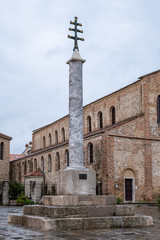 Fototapeta na wymiar Pillar in front of the church of Grado after sunset in autumn