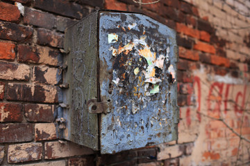old rusty mailbox on a brick wall