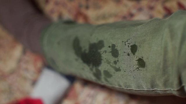 Close-up of digging drops on green jeans.