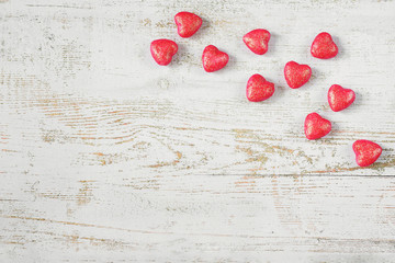 Wooden light background with red hearts. Valentine's day concept.