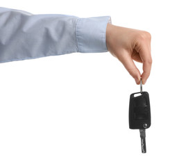 Man holding key on white background, closeup. Car buying