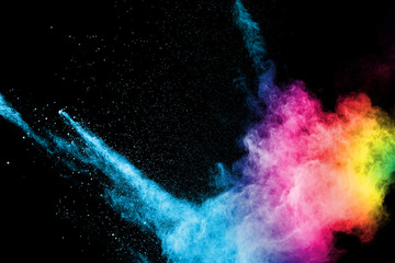 Explosion of colored powder isolated on black background. Abstract colored background. holi...