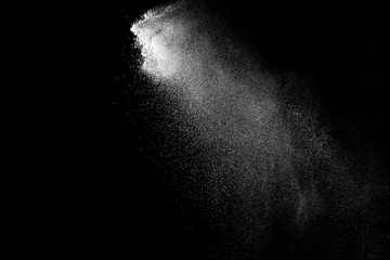 Freeze motion of white color powder exploding on dark background. 