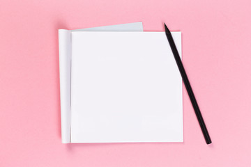 top view of blank open notebook on pink background, concept of education or new workplace