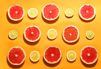 Flat lay composition with tasty ripe grapefruit slices on orange background