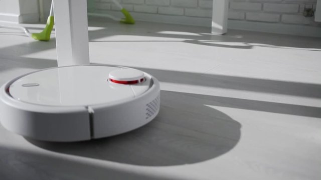 Smart House. A robot vacuum cleaner circles the table legs in a circle.