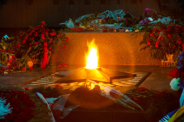 Close-up fire burns from the monument
