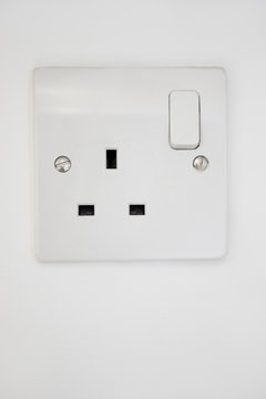 Electrical outlet attached on white wall