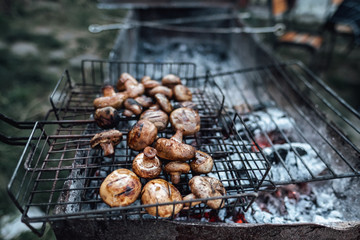 Grilled mushrooms. BBQ grill and burning coals, cooking outdoors