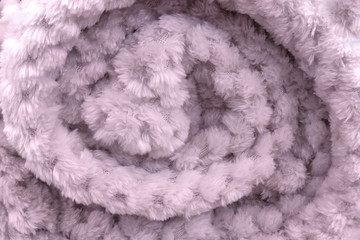 Background of a twisted soft blanket, close-up