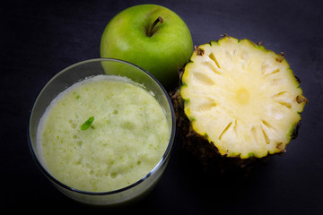 A glass of pineapple and apple juice
