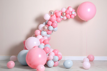 Beautiful composition with balloons near beige wall