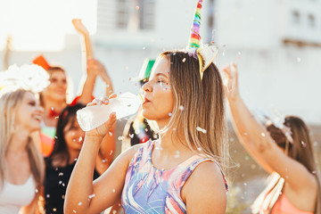 Brazilian Carnival. Woman in costume drinking water
