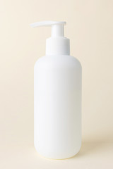 White cosmetic bottle with dispenser without a label on a light pastel background. Bottle for mockup, copyspace, minimalism. The concept of beauty, cosmetology.