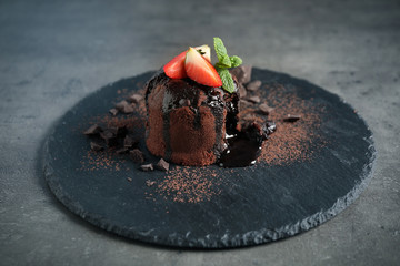 Delicious warm chocolate lava cake on grey table