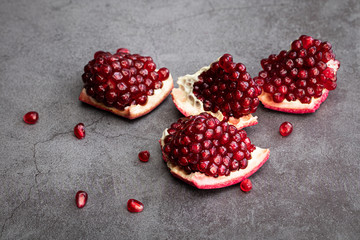 Ripe pomegranate fruits on a dark background