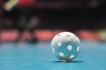 Floorball ball close up on blue floor