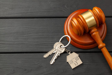 Home after divorce. Property section. Judge gavel and house keys. Buying or selling a home through...