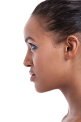 Profile shot of beautiful young woman with blue eyeshadow against white background