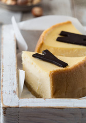 Delicious slice of new york cheesecake with word  on white background. Sweet and tasty food, coffee break concept. Classic american dessert.