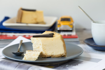 Delicious slice of new york cheesecake with word  on white background. Sweet and tasty food, coffee break concept. Classic american dessert.