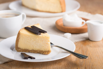 Delicious slice of new york cheesecake with word  on white background. Sweet and tasty food, coffee break concept. Classic american dessert.