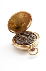 Clockwork inside pocket stopwatch over white background
