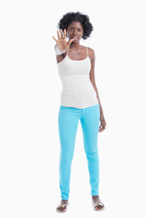 Fototapeta premium Portrait of young woman with stop gesture standing over white background