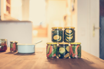 Variety of tasty vegetables in preserving glasses. Conservation of food.