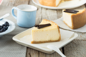 Delicious slice of new york cheesecake with word  on white background. Sweet and tasty food, coffee break concept. Classic american dessert.
