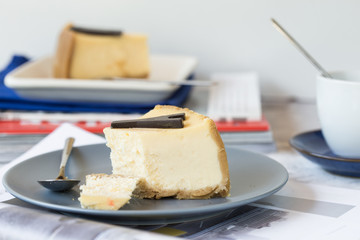 Delicious slice of new york cheesecake on  grey background, isolated. Sweet and tasty food, coffee break concep. Classic american dessert.