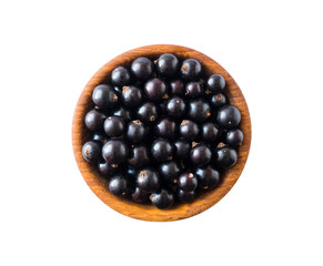Black berries on white. Blackcurrants in a wooden bowl isolated on white background. Blackcurrant isolate. Blackcurrants isolated on white background. Top view. Berries closeup.