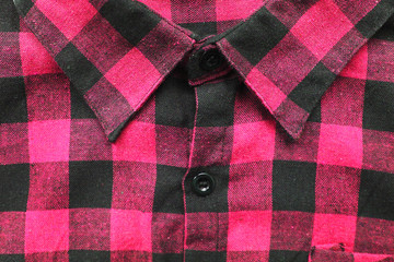 Pink colorful plaid flannel shirt with tartan pattern. Vivid pink or light purple shirt, close up...