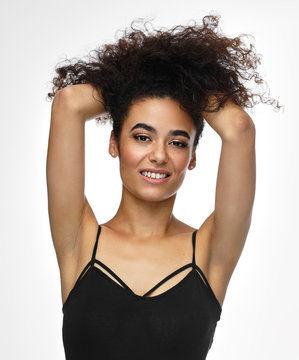 Beautiful Cheerful African American Woman Playing With Her Afro Hairstyle, Isolated On White Background