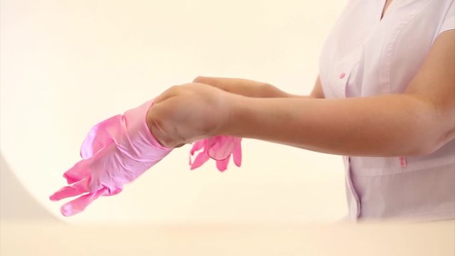 Hands in rubber gloves close-up. doctor puts wax, honey. medic is preparing for depilation. Concept of medicine, health care, beauty industry, hair removal, natural material. Copy space