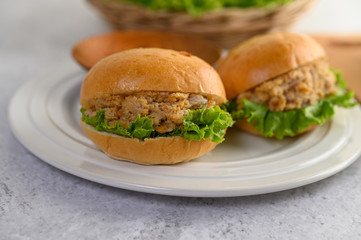 Two hamburgers placed in white dish beautifully