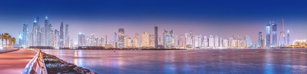 Fototapeta premium Panoramic cityscape view of skyscrapers and hotel buildings in the Dubai Marina area from the palm Jumeirah island in Dubai. Real estate and tourist attractions in the UAE