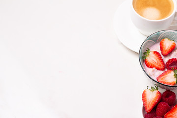 coffee, porridge and berries on a white background and place for text