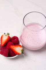 strawberries and milk in glass