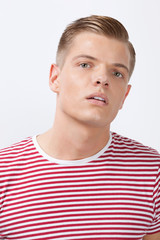 Obraz premium Portrait of a confident young man over white background