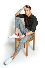 Fashion portrait of young man in shirt on white background 