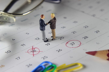 Simple Photo Illustration, Handshaking Mini Figure Businessman, Agree to doing something together...