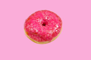 Tasty pink donut on pink background