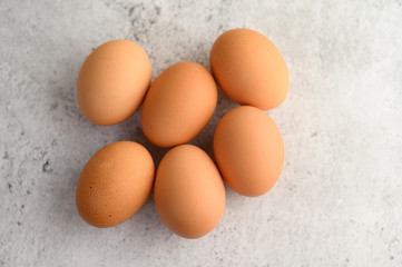 Organic brown eggs several on the floor,