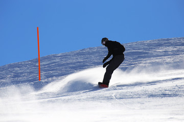 Snowboarder riding the slope