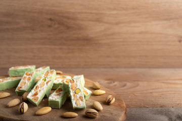 Homemade pistachio nougat on a wooden table background