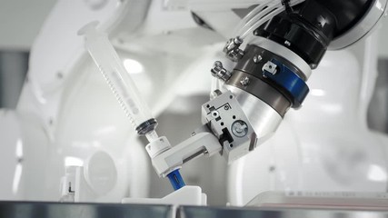 The innovative arms of a robotic arm make an injection of chemotherapy for a cancer patient. New technologies in medicine. Two manipulators draw medicine into a syringe. Hazardous substance injected. - Powered by Adobe