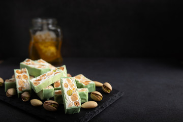 Homemade pistachio nougat on a dark rustic background